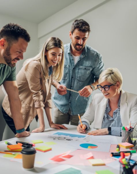 Diverse creative business team working together around a laptop in the meeting room of a modern company. Brainstorming concept. Office life. Multiracial colleagues.